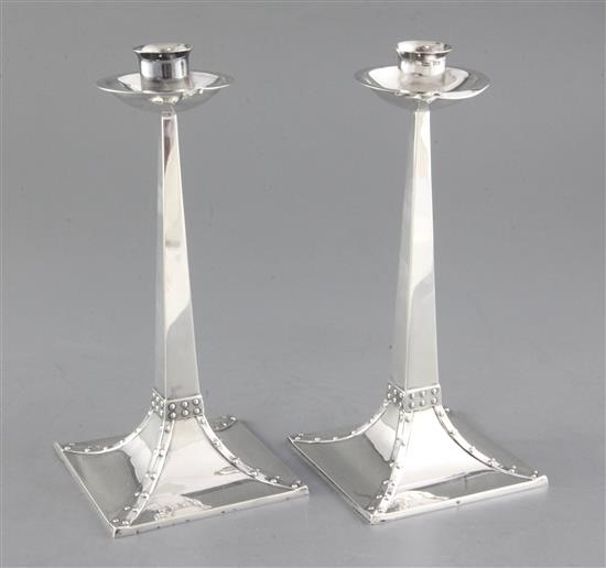 An Edwardian pair of Arts & Crafts silver candlesticks, by James Dixon & Sons, 22cm.